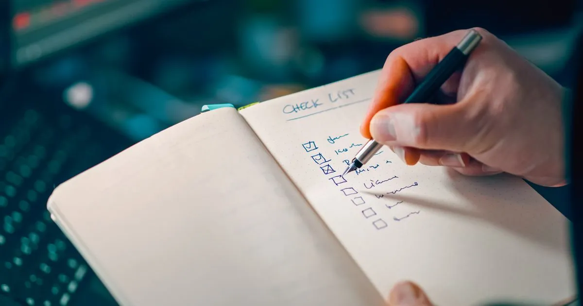Checklist for choosing between debt relief solutions written in a notebook